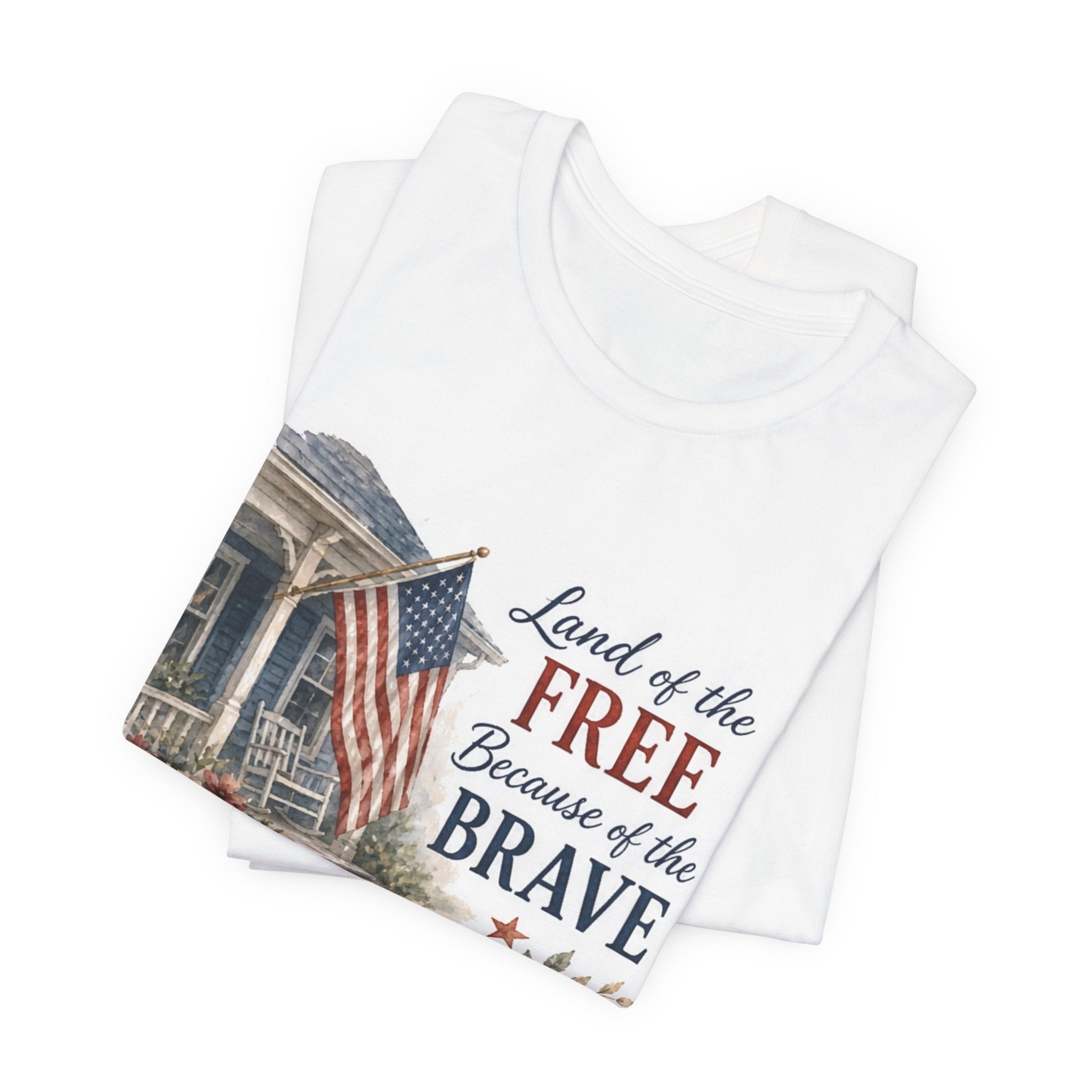 White t-shirt with "Land of the FREE Because of the BRAVE" and American flag design.