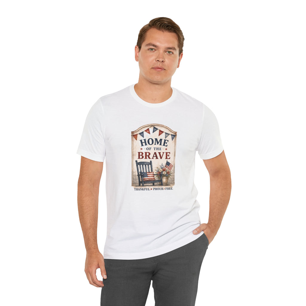 Man wearing white t-shirt with "Home of the Brave" graphic featuring chair and flag.